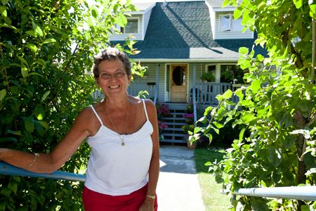 Judy Sheppard in front of a house